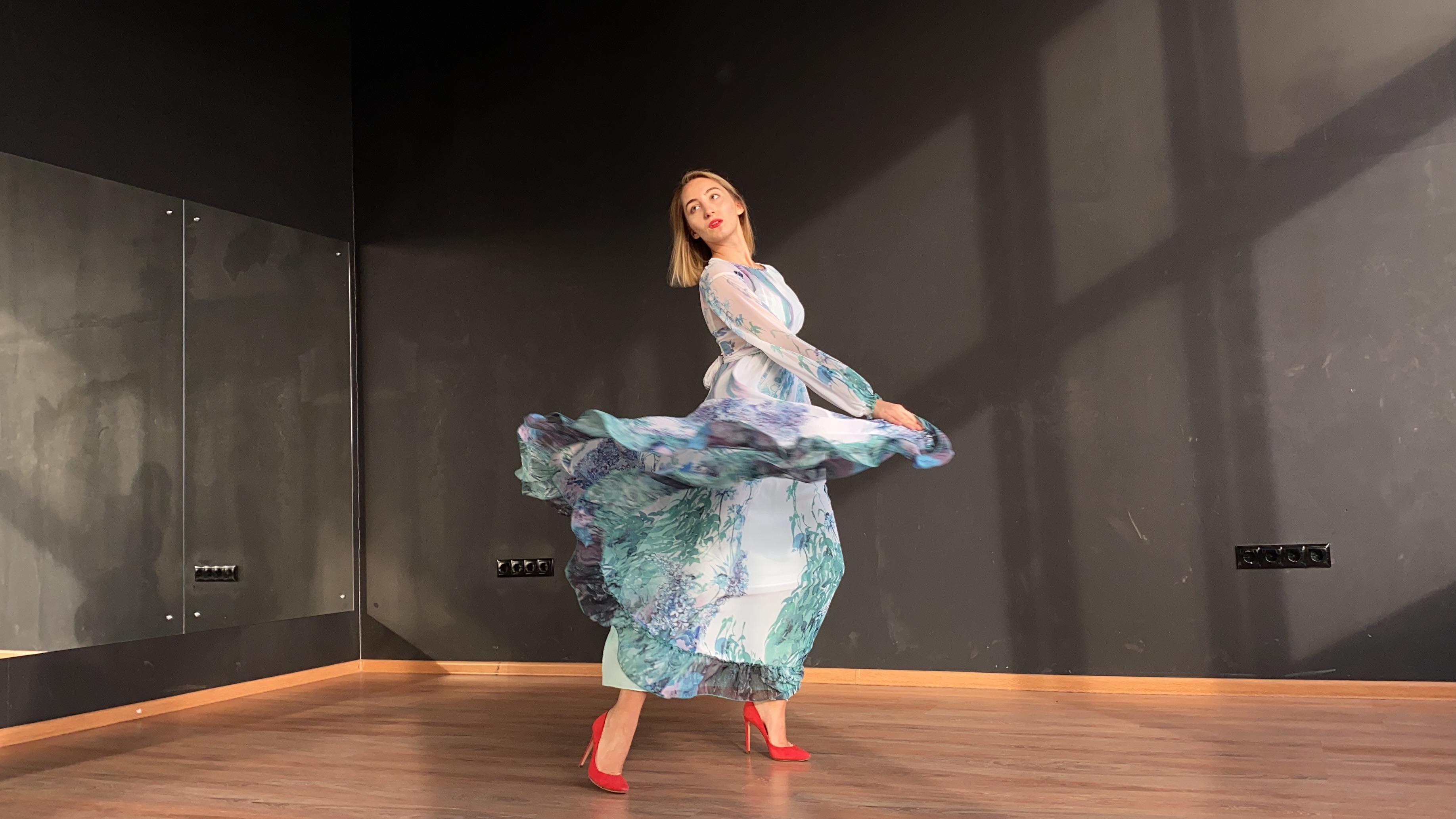 A workshop participant exploring movement through a flowing dress