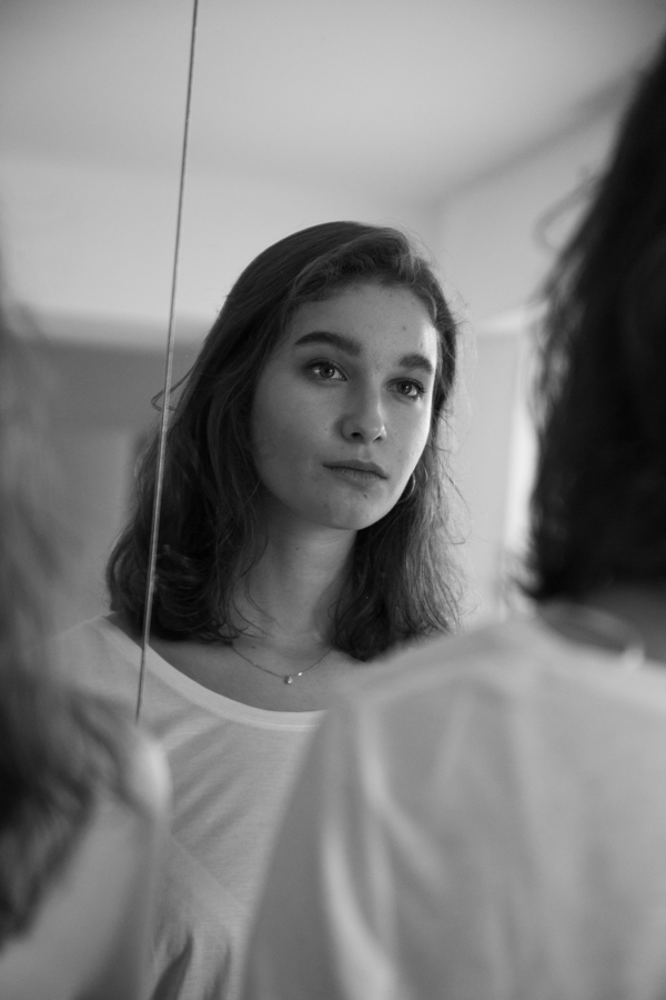 A workshop participant practising beside her reflection