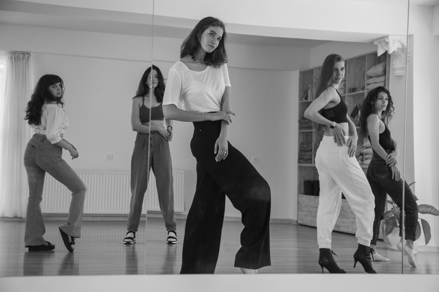 Anasta demonstrating a pose with workshop participants in a mirrored studio